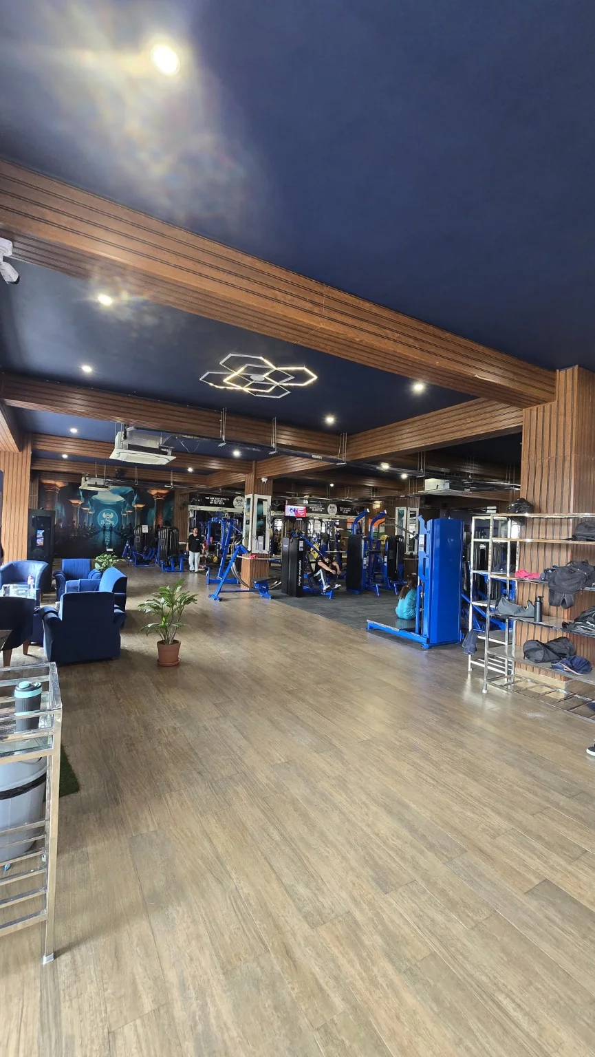 Gym floor with lounge seating, blue resistance equipment and timber interior