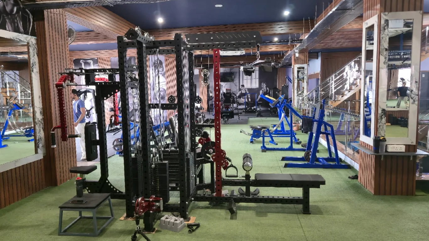 Power rack and cable station surrounded by blue strength machines