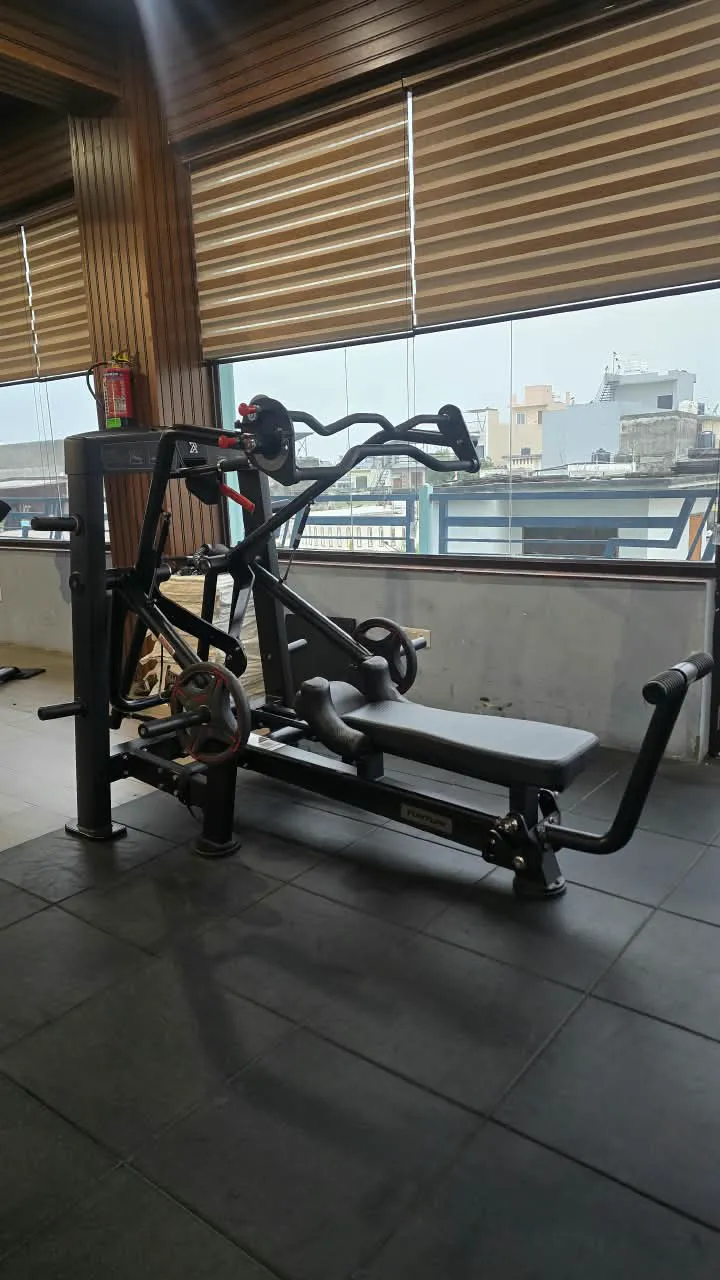Black plate-loaded bench and row station beside the window overlooking the neighbourhood
