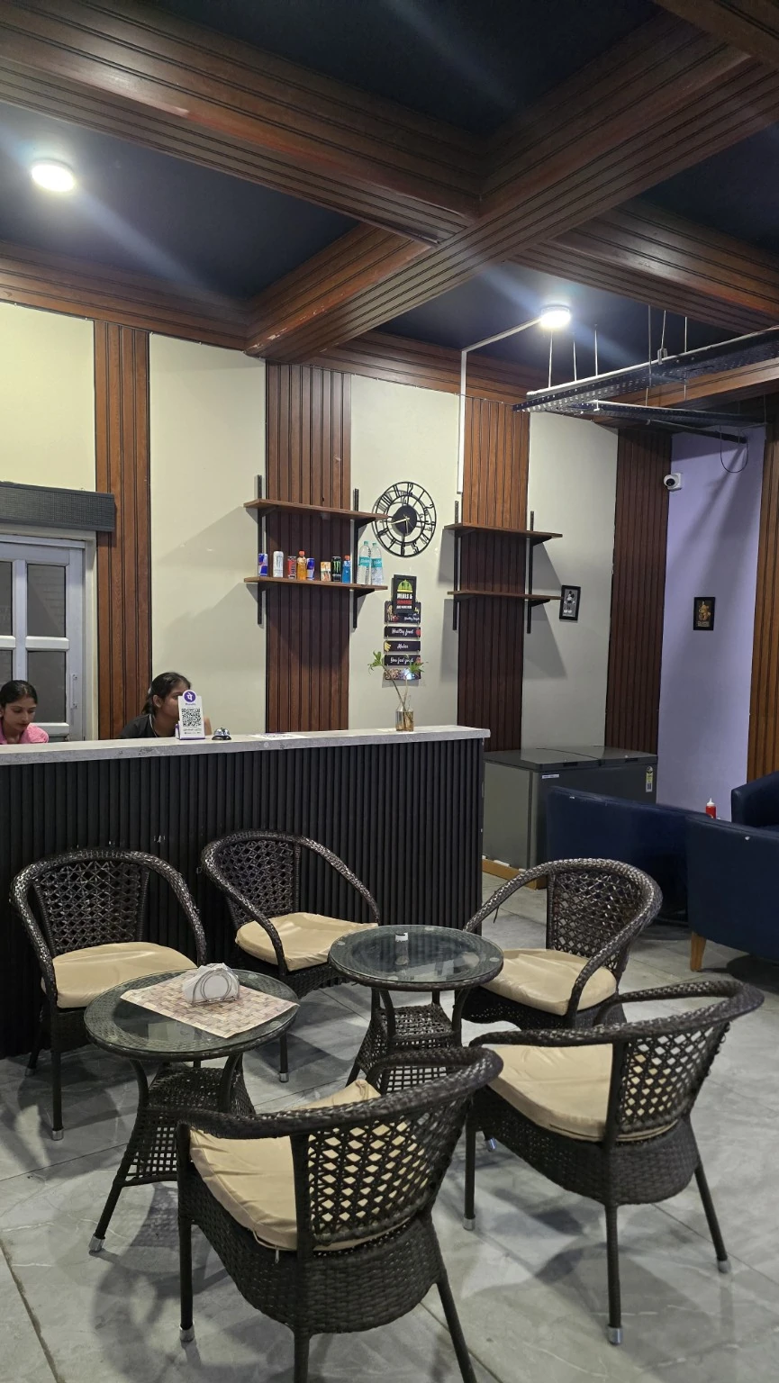 Café counter and wicker chairs around glass tables, with timber interior and a lounge seat